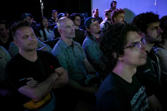 A shot of a row of audience members listening intently to the keynote presentation.