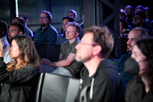 Dave Di Biase, from Solid, in the audience as he listens intently to Fred K. Schott speak on stage.