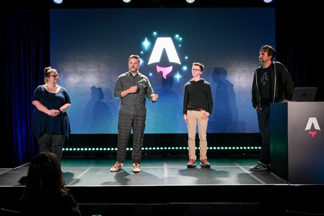 Keynote speakers on stage. From left to right: Sarah Rainsberger, Matthew Phillips, Ben Holmes, and Fred K. Schott (next to the podium).