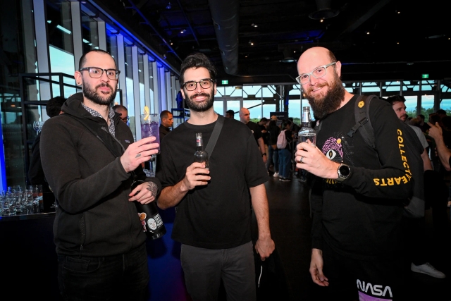 Guests pose for a group photo with their drinks.